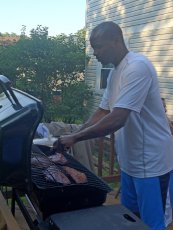 Adoptive Family Photo: Kalias Showing Off His BBQ Skills, click to view bigger version