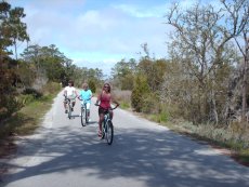 Adoptive Family Photo: Laurie, Her Mom, and a Friend Riding Bikes on Bald Head Island, click to view bigger version