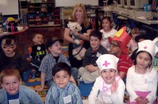 Adoptive Family Photo: Gillian and Reggie with Kindergarten<br> Class on Career Day, click to view bigger version