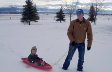 Adoptive Family Photo: Fred and Luke Sledding, click to view bigger version
