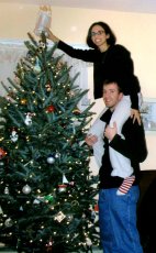 Adoptive Family Photo: Putting the Angel on Top <br>of the Christmas Tree<br> Takes Teamwork, click to view bigger version