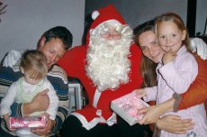 Adoptive Family Photo: Rainer is Santa Clause for Seven Girls, click to view bigger version