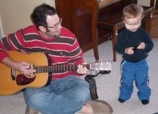 Adoptive Family Photo: Braiden Loves to Hear Daddy<br>Play Silly Songs on the Guitar, click to view bigger version