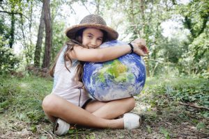 Little girl embracing world globe
