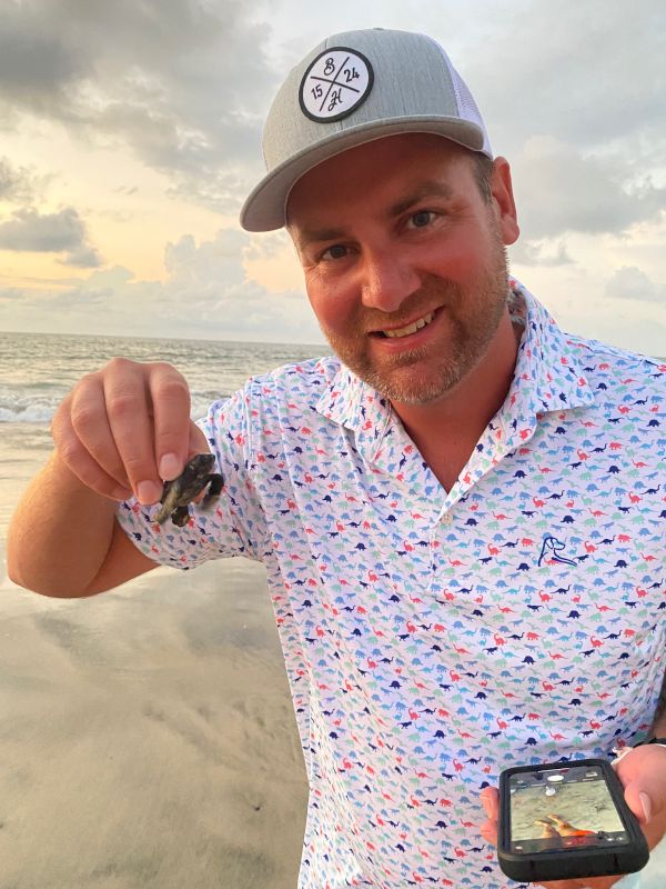 Jeff Releasing a Baby Turtle to the Ocean