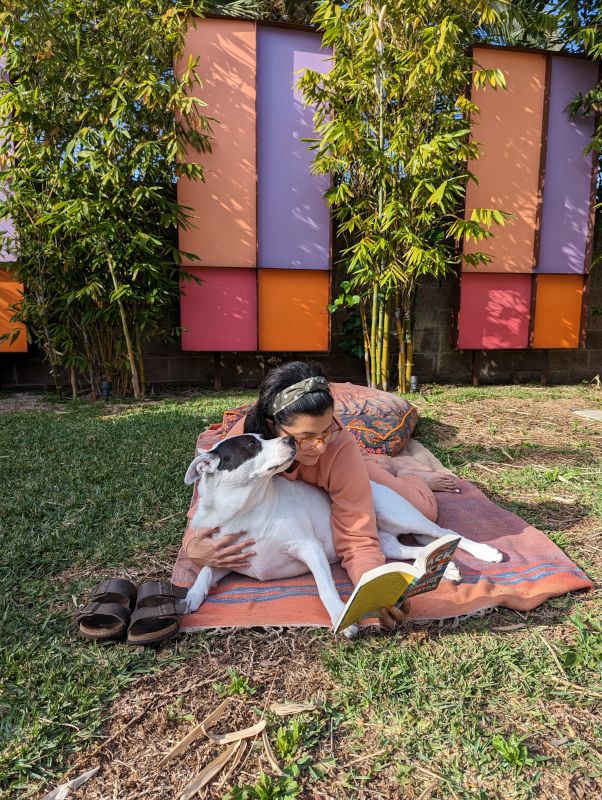 Sumi Reading in Our Backyard With Our Dog, Zelda