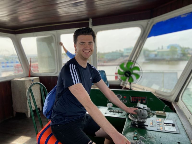Alex in Ferry Captain's Seat in Vietnam