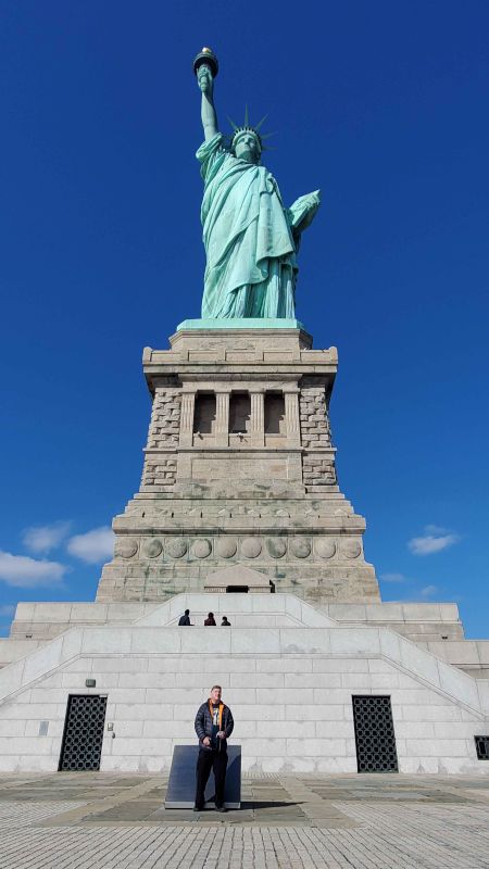 Brian in Front of the Statue of Liberty