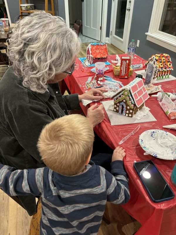 Zeke Decorating a Gingerbread House with Grandma
