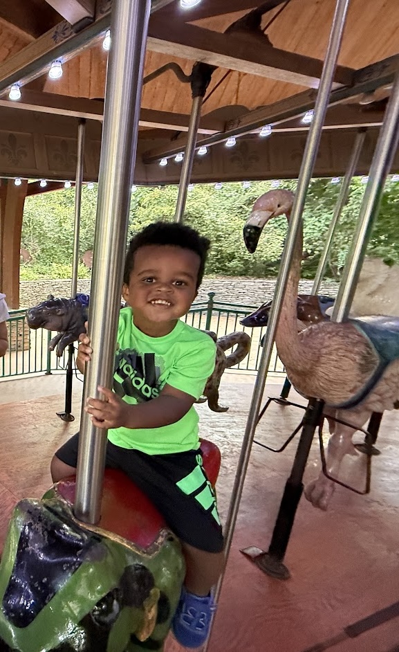 Drew Riding a Coursel at the Zoo