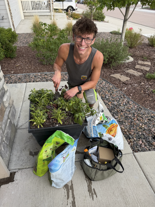 Derek potting up flowers for our front door