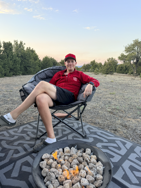 Tyson relaxing by the fire while camping at our family property in Southern Colorado