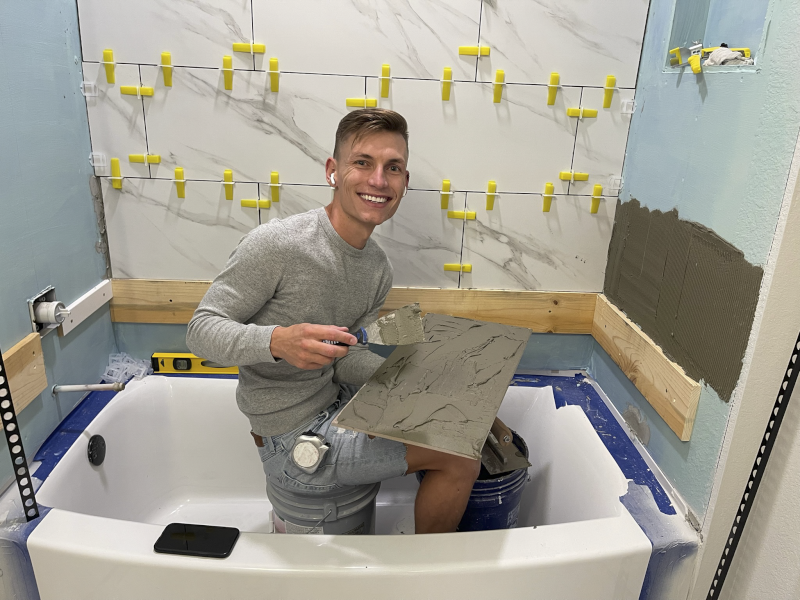 Derek Tiling Our Shower During Our Basement Build
