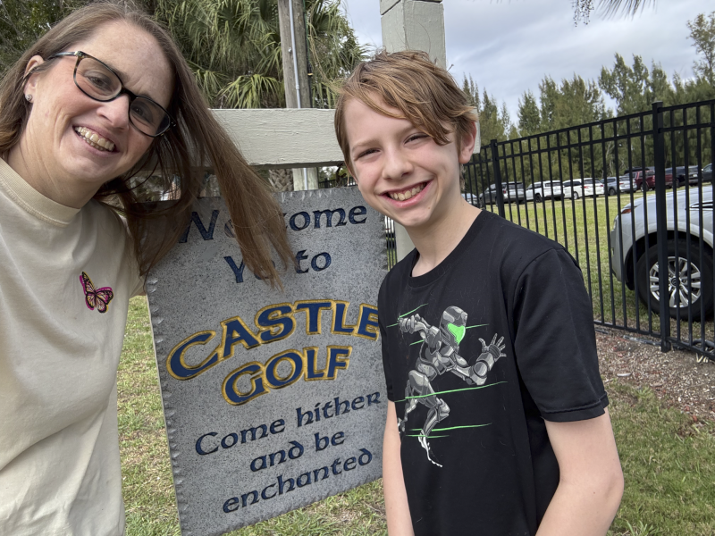 Elizabeth and Isaac Playing Miniature Golf