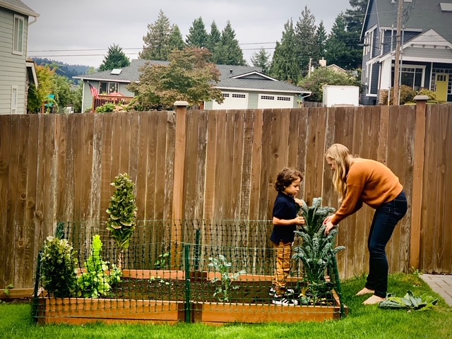 Kelsey & Our Nephew Cutting Kale From Our Garden